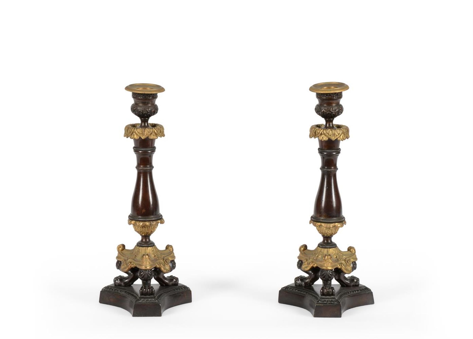 A PAIR OF PATINATED AND GILT METAL CANDLESTICKS IN LOUIS PHILIPPE STYLE