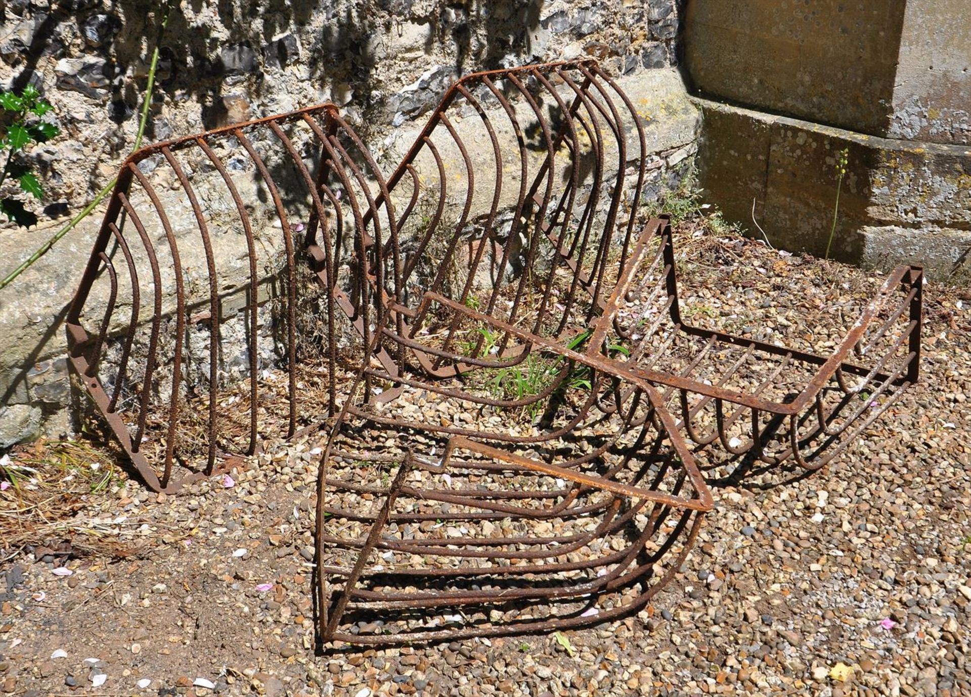 A SET OF FOUR VICTORIAN IRON WALL MOUNTED MANGERS