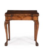 A WALNUT AND CROSSBANDED CONCERTINA ACTION CARD TABLE IN IRISH GEORGE II STYLE