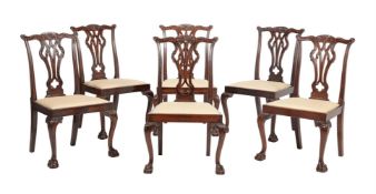 A SET OF SIX LATE VICTORIAN CARVED MAHOGANY DINING CHAIRS