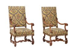 A PAIR OF CARVED WALNUT AND UPHOLSTERED OPEN ARMCHAIRS IN LOUIS XIV STYLE