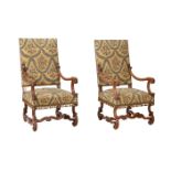 A PAIR OF CARVED WALNUT AND UPHOLSTERED OPEN ARMCHAIRS IN LOUIS XIV STYLE