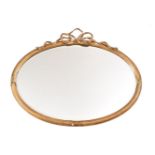 A GILTWOOD AND GESSO OVAL WALL MIRRORIN GEORGE III STYLE