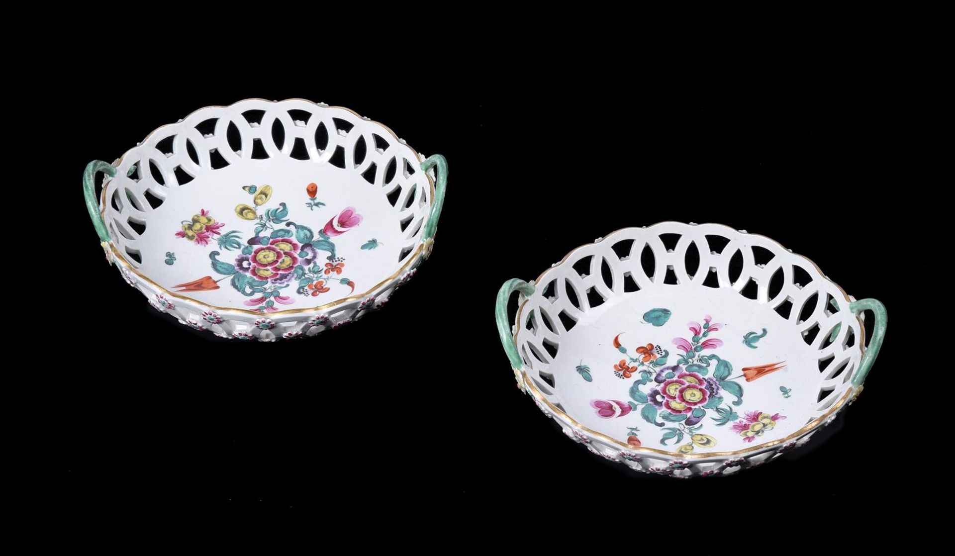 A PAIR OF WORCESTER POLYCHROME PIERCED TWO HANDLED ROUND BASKETS