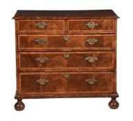 A WALNUT CHEST OF DRAWERS