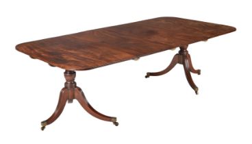 A MAHOGANY TWIN PEDESTAL DINING TABLE IN REGENCY STYLE