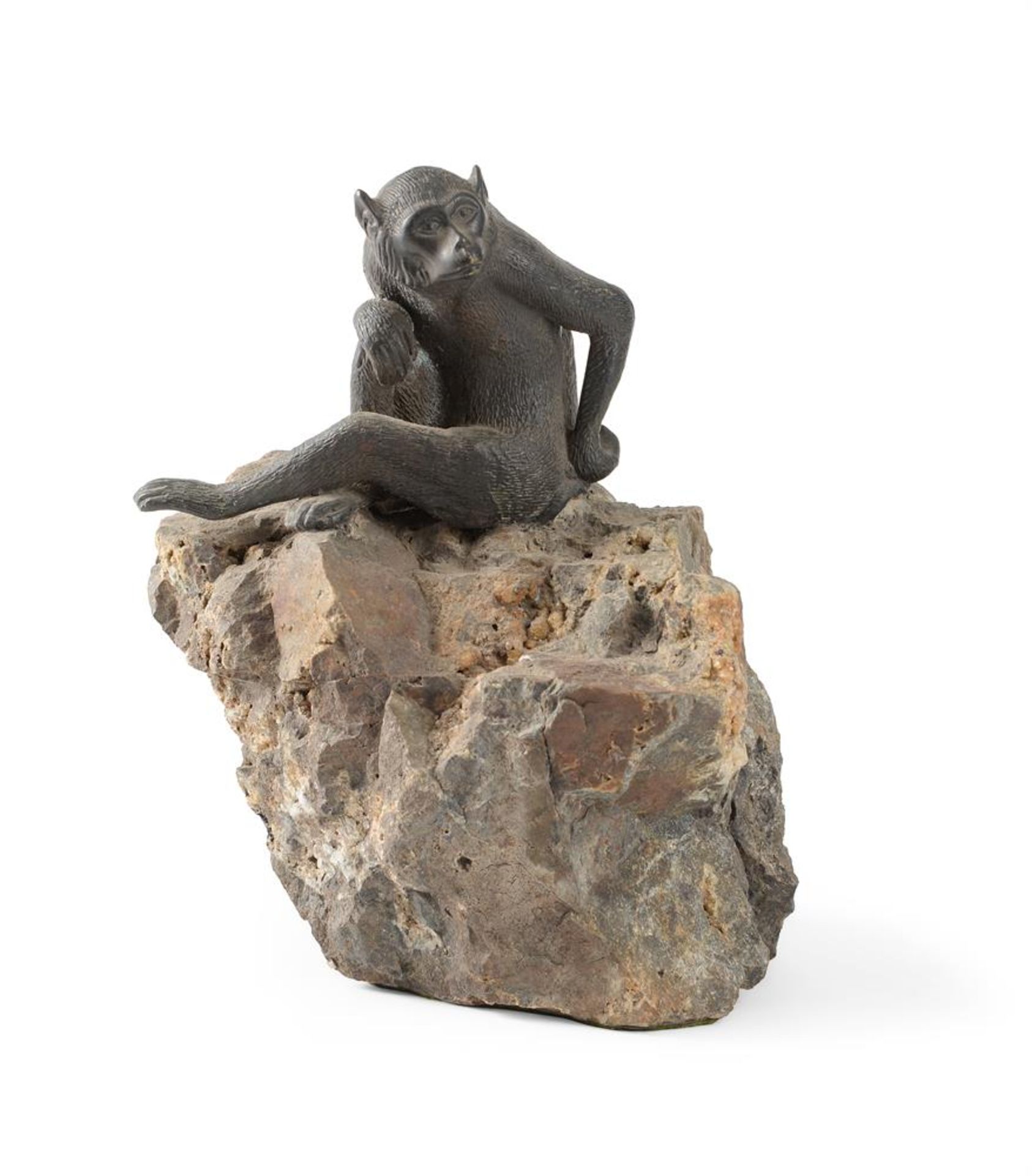 A JAPANESE BRONZE MODEL OF A MONKEY ON A NATURAL ROCK BASE