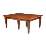 A MAHOGANY EXTENDING DINING TABLE