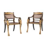 A PAIR OF EBONISED AND PARCEL GILT OPEN ARMCHAIRS