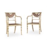 A PAIR OF CREAM PAINTED AND CANED OPEN ARMCHAIRS