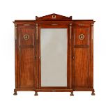 A FRENCH MAHOGANY AND GILT METAL MOUNTED WARDROBE IN EMPIRE STYLE