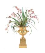 A GILTWOOD AND COMPOSITION URN ON STAND IN NEOCLASSICAL TASTE