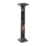 A BLACK VEINED MARBLE PEDESTAL COLUMN