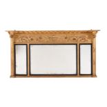 A REGENCY GILTWOOD AND COMPOSITION OVERMANTEL WALL MIRROR
