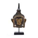 A BURMESE LACQUER HEAD OF BUDDHA20TH CENTURYwith inlaid coloured glass details