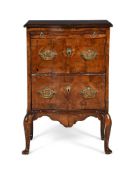 A WALNUT SERPENTINE CHEST OR COMMODE