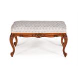 A CARVED BEECH AND UPHOLSTERED CENTRE STOOL IN VICTORIAN TASTE