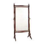 A GEORGE IV MAHOGANY AND GILT METAL MOUNTED CHEVAL MIRROR