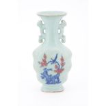 A CHINESE CELADON GROUND TWIN HANDLED VASE