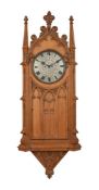 A VICTORIAN GOTHIC REVIVAL CARVED OAK WALL CLOCK
