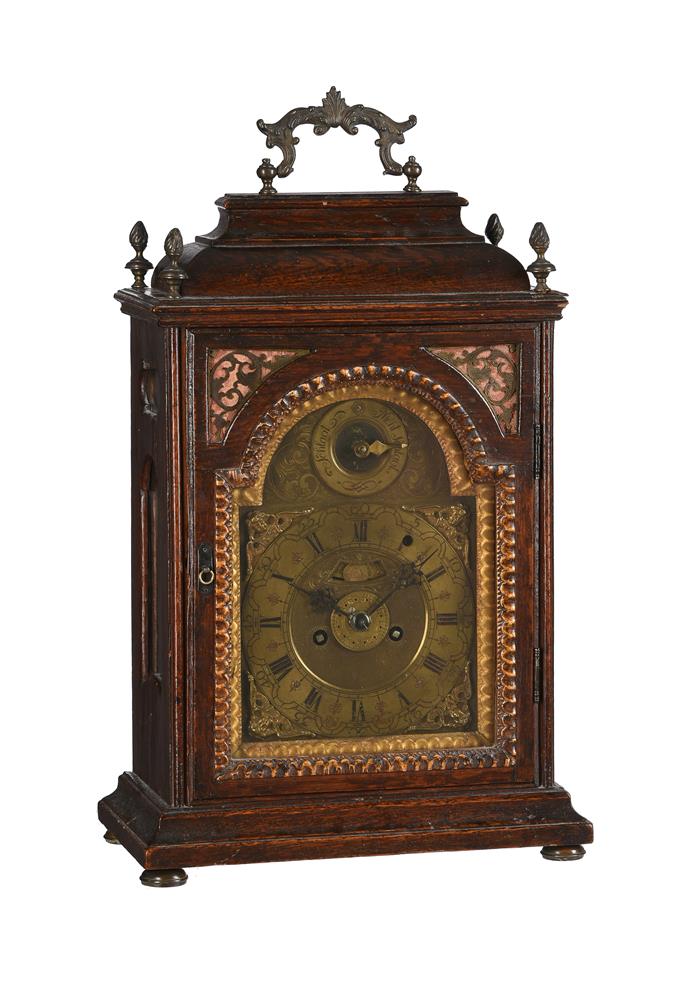 AN AUSTRIAN OAK CASED TABLE CLOCK WITH TRIP-HOUR REPEAT