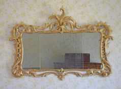 A GEORGE III CARVED GILTWOOD WALL MIRROR, CIRCA 1780