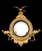 A GEORGE III CARVED GILTWOOD CONVEX MIRROR, CIRCA 1810