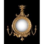 A REGENCY CARVED GILTWOOD CONVEX MIRROR, CIRCA 1820