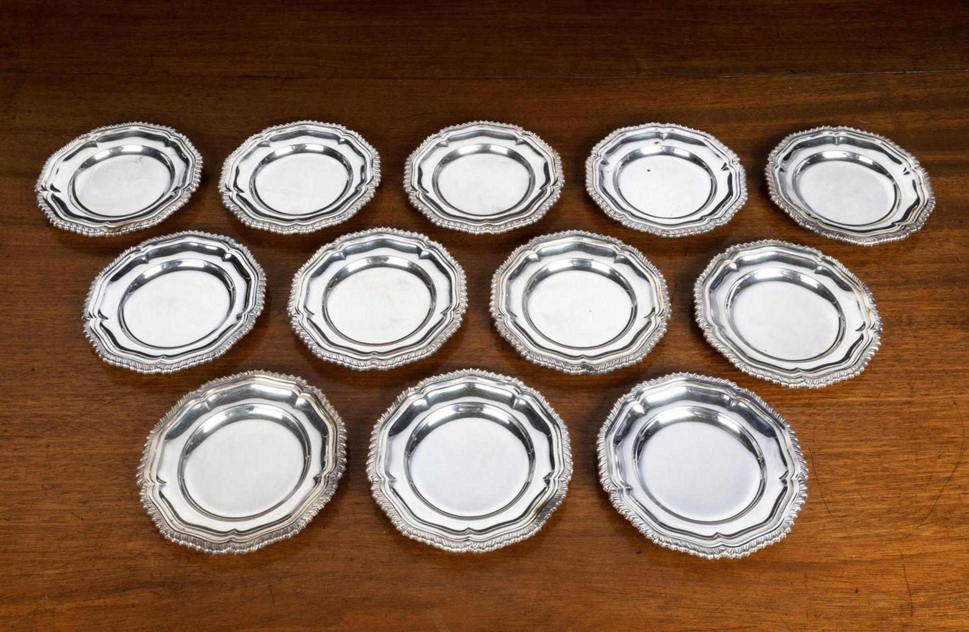 A SET OF TEN SILVER DISHES AND TWELVE STANDS, NAT LESLIE LTD., LONDON 1966