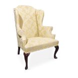 A GEORGE I WALNUT AND UPHOLSTERED WING ARMCHAIR, CIRCA 1720