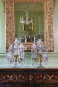 A PAIR OF ORNATE CUT GLASS, GILT BRONZE AND METAL MOUNTED FIVE LIGHT TABLE CANDELABRA