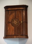 A GEORGE III MAHOGANY, BOXWOOD AND BRASS MARQUETRY HANGING CORNER CUPBOARD, CIRCA 1780