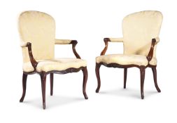 A PAIR OF GEORGE III MAHOGANY AND UPHOLSTERED OPEN ARMCHAIRS, CIRCA 1775