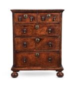 A QUEEN ANNE WALNUT AND FEATHERBANDED CHEST OF DRAWERS, CIRCA 1710