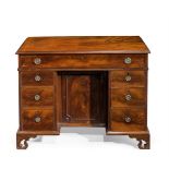 A GEORGE III MAHOGANY KNEEHOLE DESK, IN THE MANNER OF THOMAS CHIPPENDALE