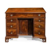 A GEORGE III MAHOGANY KNEEHOLE DESK, IN THE MANNER OF THOMAS CHIPPENDALE