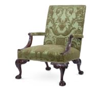 A CARVED MAHOGANY AND UPHOLSTERED GAINSBOROUGH ARMCHAIR, IN GEORGE II STYLE