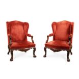 A PAIR OF CARVED WALNUT AND UPHOLSTERED WING ARMCHAIRS, IN IRISH GEORGE II STYLE