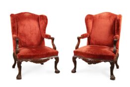 A PAIR OF CARVED WALNUT AND UPHOLSTERED WING ARMCHAIRS, IN IRISH GEORGE II STYLE