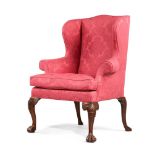 A GEORGE II WALNUT AND UPHOLSTERED WING ARMCHAIR, CIRCA 1750