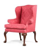 A GEORGE II WALNUT AND UPHOLSTERED WING ARMCHAIR, CIRCA 1750