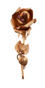 A RUBY AND GOLD COLOURED ROSE BROOCH