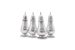 A SET OF FOUR AMERICAN SILVER COLOURED BALUSTER PEPPERETTES