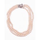 A THREE STRAND CULTURED PEARL NECKLACE