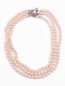 A THREE STRAND CULTURED PEARL NECKLACE
