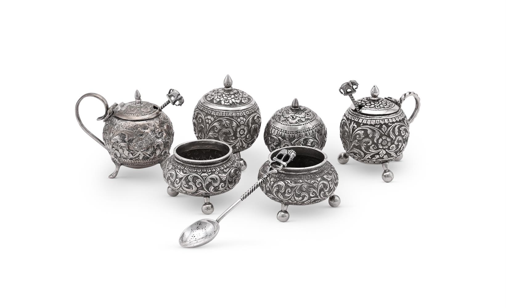 AN INDIAN SILVER FOUR PIECE GLOBULAR CRUET SET