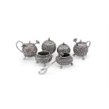 AN INDIAN SILVER FOUR PIECE GLOBULAR CRUET SET