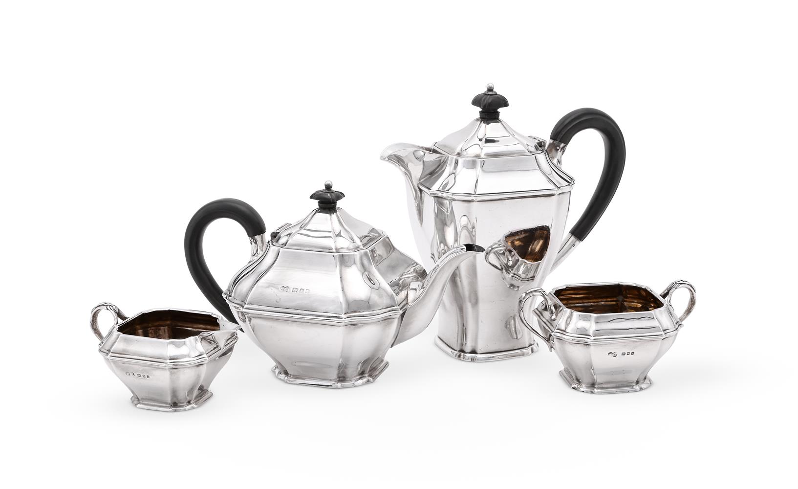 A SILVER THREE PIECE LOBED SQUARE TEA SET