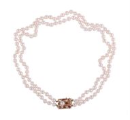 A TWO ROW CULTURED PEARL NECKLACE WITH RUBY ACCENTED GOLD COLOURED CLASP