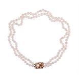 A TWO ROW CULTURED PEARL NECKLACE WITH RUBY ACCENTED GOLD COLOURED CLASP